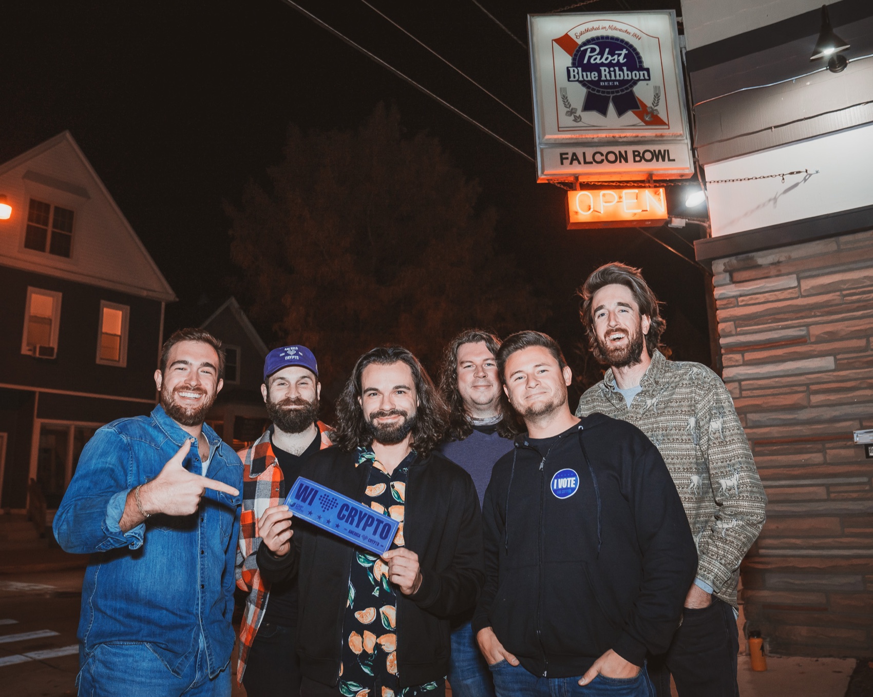Get Out The Vote — the team outside Falcon Bowl holding a WI Crypto sign, Milwaukee