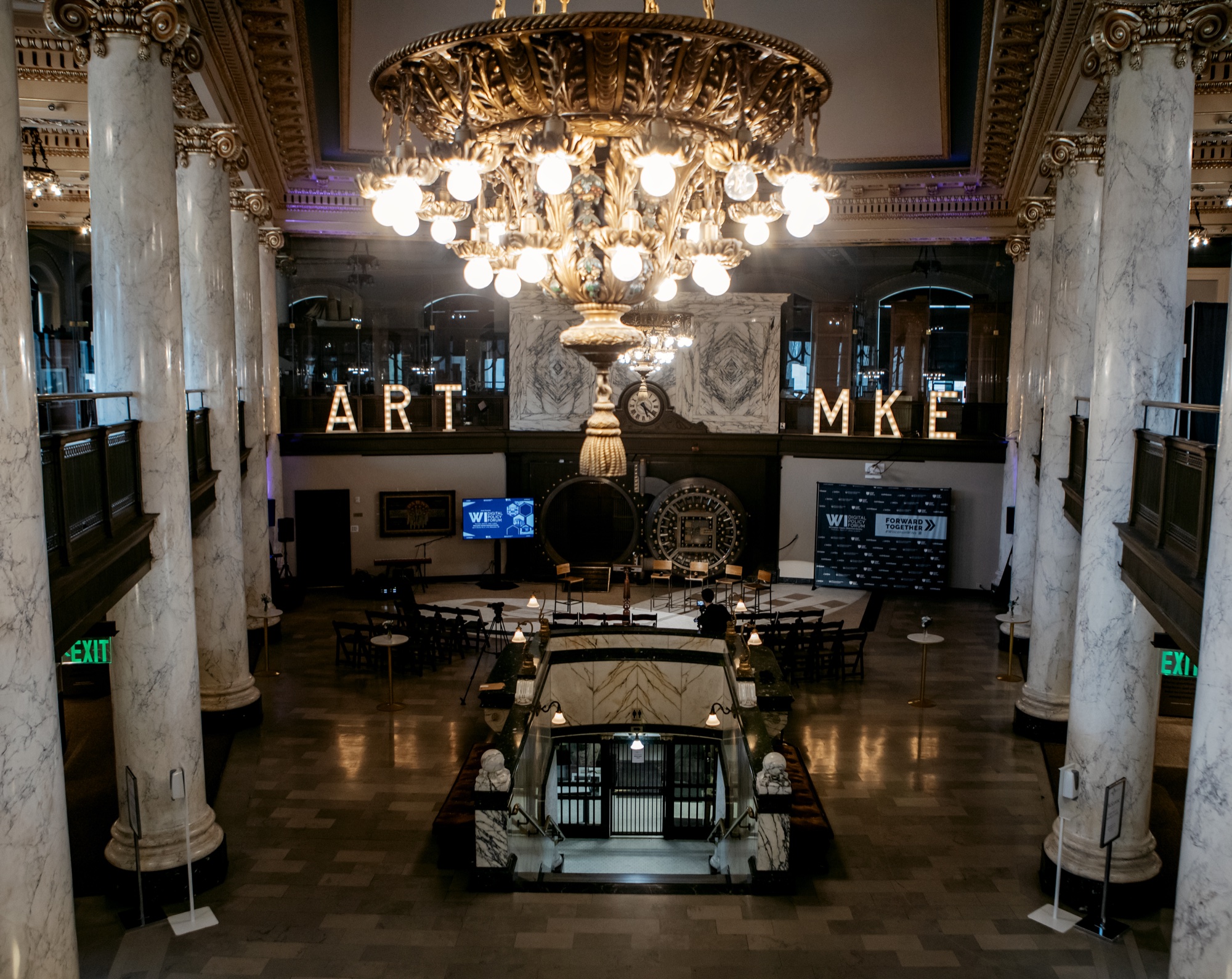 Wisconsin Digital Policy Forum — the Milwaukee County Historical Society grand hall, set and staged before doors, with the branded ‘ART · MKE’ marquee and chandelier